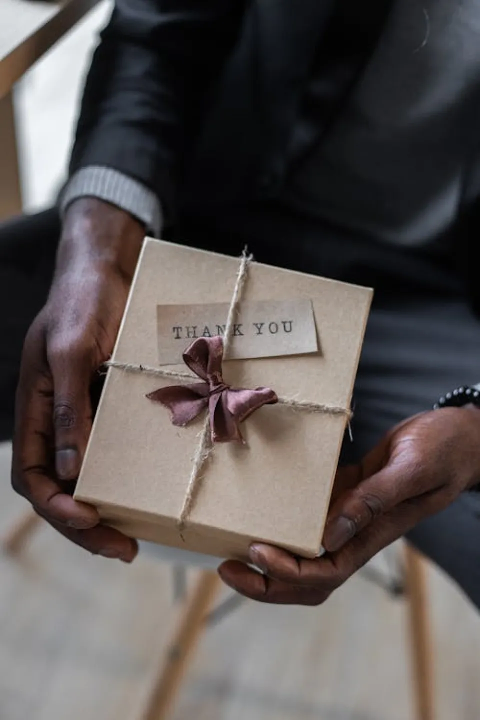 Free Crop black man with gift box Stock Photo